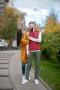 Positive delighted couple having a walk on the street