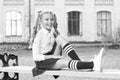 Pleasant minutes of rest. Time to relax and have fun. Relaxing in school yard. Perfect schoolgirl relaxing between