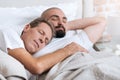 Pleasant non-traditional couple sleeping in the one bed Royalty Free Stock Photo