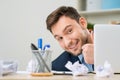 Pleasant office worker hiding behind laptop