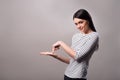 Pleasant positive girl standing isolated on grey background Royalty Free Stock Photo