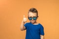 Pleasant satisfied boy shows thumbs up looking at camera, portrait. Attractive smiling boy in blue casual t-shirt posing Royalty Free Stock Photo