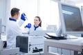 Pleasant scientist admiring professional work of her colleague