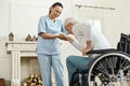 Pleasant senior man holding caregivers hand