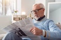 Pleasant senior man reading article in the newspaper Royalty Free Stock Photo