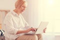 Pleasant senior woman using her laptop at home Royalty Free Stock Photo