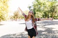 Pleasant slim girl dancing in summer park. Positive caucasian lady funny posing on nature backgroun