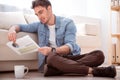 Pleasant smiling man sitting on the floor Royalty Free Stock Photo