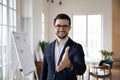 Pleasant smiling trustful manager in suit reaching out hand. Royalty Free Stock Photo