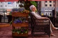 Pleasant smiling woman is resting in the armchair and enjoying her life