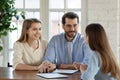 Pleasant smiling young married couple meeting with female bank consultant Royalty Free Stock Photo