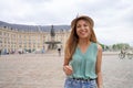 Pleasant stylish girl in Bordeaux, France. Young tourist woman looks at camera in Place de la Bourse square, Bordeaux, France Royalty Free Stock Photo