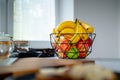 Pleasant sunlight accentuates a banana in a glass bowl on the kitchen counter Royalty Free Stock Photo