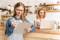 Pleasant teenage barista checking her to-do list Royalty Free Stock Photo