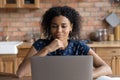 Pleasant thoughtful young african american businesswoman working on computer. Royalty Free Stock Photo