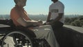 Pleasant wheelchaired man having a nice conversation with