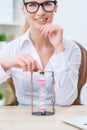 Pleasant woman holding sandglass