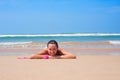 Pleasant woman lying on the sand