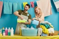 Pleasant young couple preparing water fow washing clothes by hand Royalty Free Stock Photo