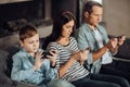 Pleasant young family being addicted to their phones