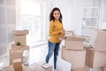 Pleasant young girl taking books out of the box Royalty Free Stock Photo