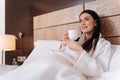 Pleasant young woman lying in her bed Royalty Free Stock Photo