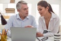 Pleasant young woman sitting with her colleague Royalty Free Stock Photo