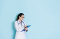 Pleasantly female clinic doctor holding board Royalty Free Stock Photo