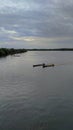 some traditional amazon canoes traveling in the afternoon