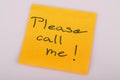 Please call me note on orange sticker note on white Royalty Free Stock Photo