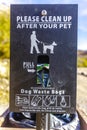 Please clean up after your pet sign with bags Royalty Free Stock Photo
