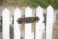 Please close gate sign on white wooden fence Royalty Free Stock Photo