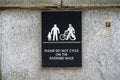 Please Do Not Cycle On The Riverside Walk - sign on wall Royalty Free Stock Photo