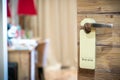 Do not disturb sign hanging on open door in a hotel Royalty Free Stock Photo