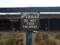 Please do not feed the birds sign and wire fence Royalty Free Stock Photo