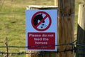 Please Do Not Feed The Horses Sign on a Paddock Fence Post