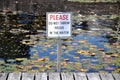 Please do not throw rocks in the water sign Royalty Free Stock Photo