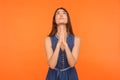 Please, God I`m begging! Upset brunette woman holding cupped hands and praying heartily Royalty Free Stock Photo