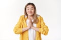 Please god make dream come true. Hopeful silly cute asian blond young girl close eyes smiling faithfully press palms Royalty Free Stock Photo