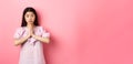 Please help me. Cute asian woman begging you, holding hands in pray and asking for favour, need something, standing Royalty Free Stock Photo