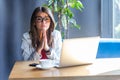 Please help me! Portrait of hopeful beautiful stylish brunette young woman in glasses sitting, looking at camera with worry face Royalty Free Stock Photo