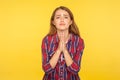 Please, I`m begging! Portrait of desperate ginger girl in shirt keeping arms in prayer gesture and asking forgiveness