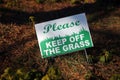 Please, Keep of the grass sign on a fall grass Royalty Free Stock Photo