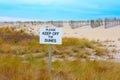 PLEASE KEEP OFF THE DUNES sign with beautiful dunes and blue sky background Royalty Free Stock Photo