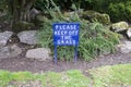 Please keep off grass blue sign in private garden Royalty Free Stock Photo