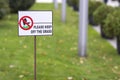 Please keep off the grass sign on green lawn grass blurred bokeh background on sunny summer day. City lifestyle and nature Royalty Free Stock Photo