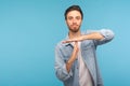 Please, need pause! Portrait of man in worker denim shirt showing time out, refusing and doing enough limit gesture