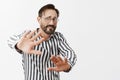 Please not in face. Insecure scared adult man in glasses and striped shirt, being in foreign city and coming wrong place Royalty Free Stock Photo