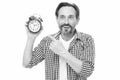 Please observe time. Mature man pointing finger at alarm clock. Mature timekeeper with analog clock. Bearded senior man