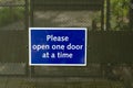 Please Open One Door Time Safety Notice Royalty Free Stock Photo